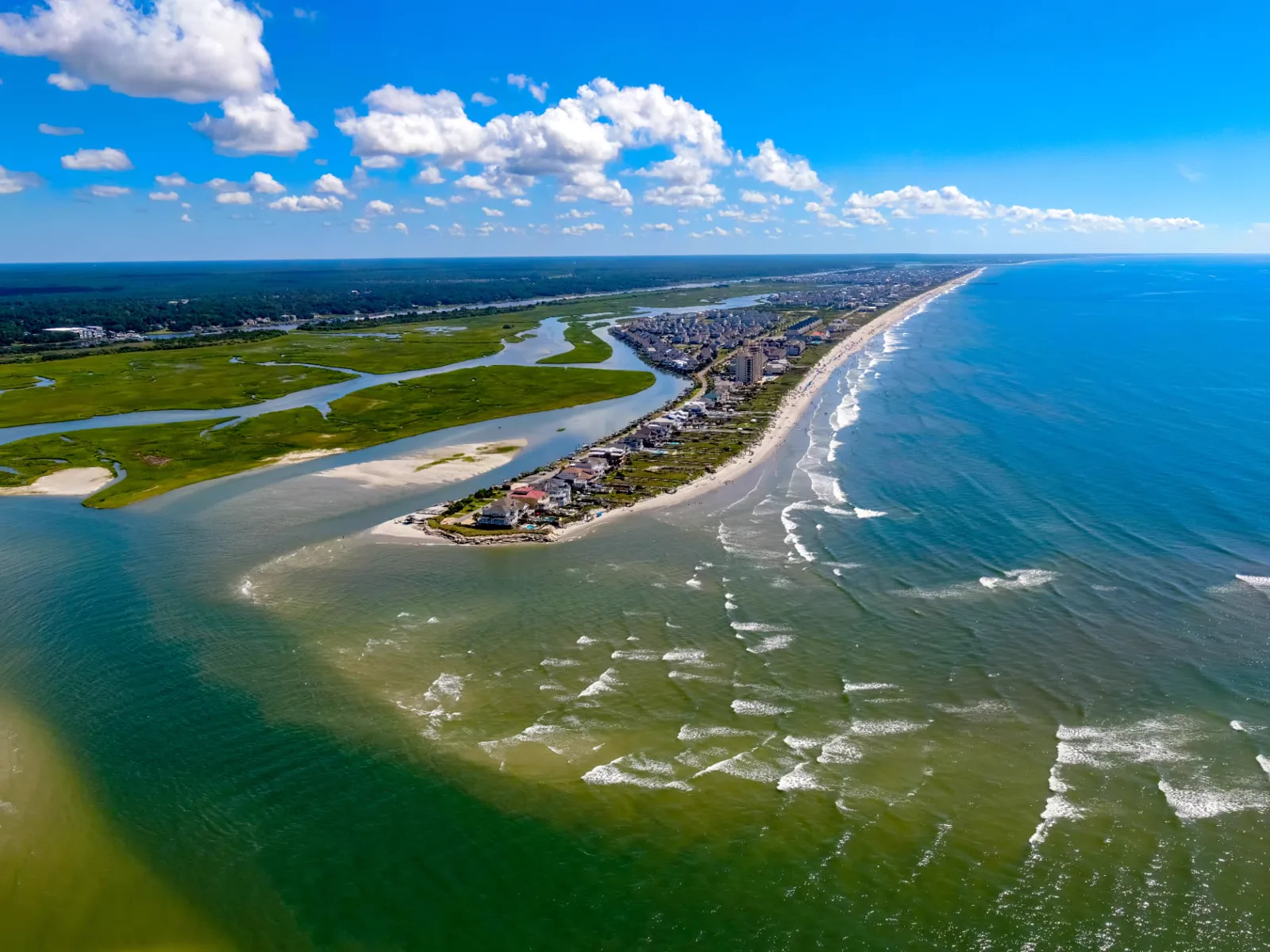 Aerial view of the Ocean Isle Beach west end coastline, marsh waterways, and inlet