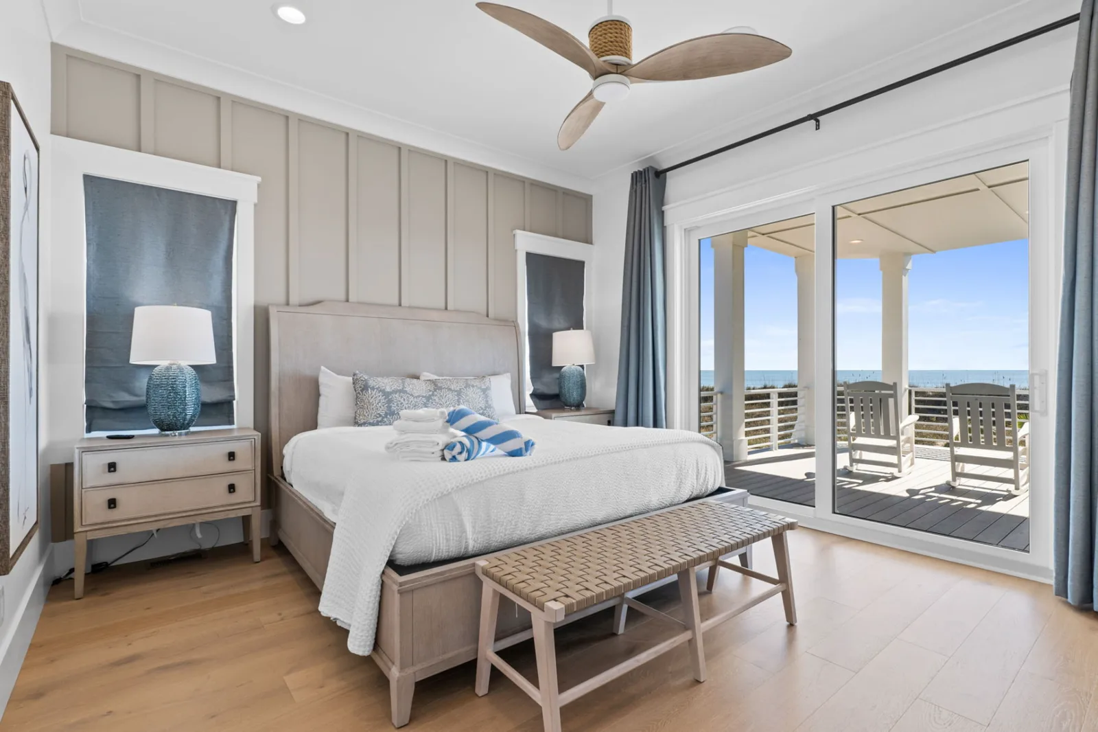 Oceanfront bedroom with sliding glass doors opening to an ocean-view balcony